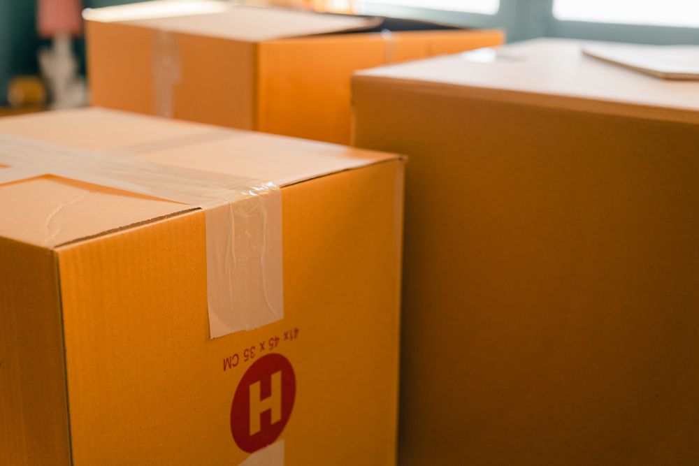 Cardboard containers sealed with sticky tape for relocation