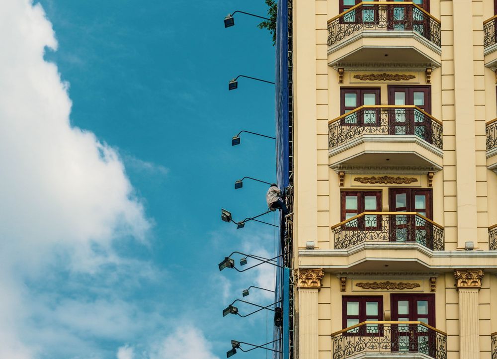 A stylish urban building with ornate balconies under a clear blue sky.